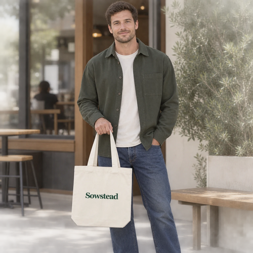 A man carrying the natural Sowstead tote by its handles outside a neighbourhood café.